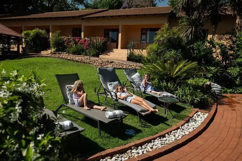 Guests relaxing on garden loungers at Little Tuscany